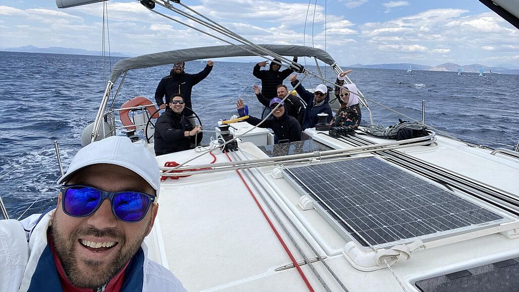 Photo of people on board of a boat waving to the 